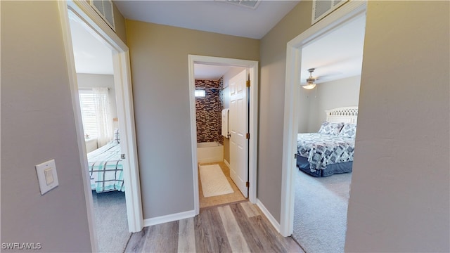 hallway with light hardwood / wood-style flooring