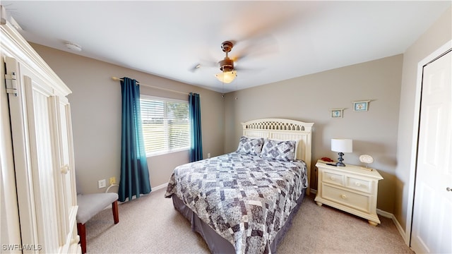 bedroom with ceiling fan and light colored carpet