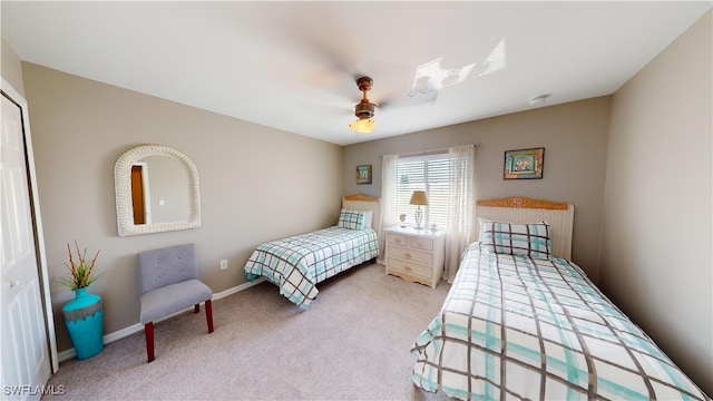 bedroom with ceiling fan, a closet, and light carpet