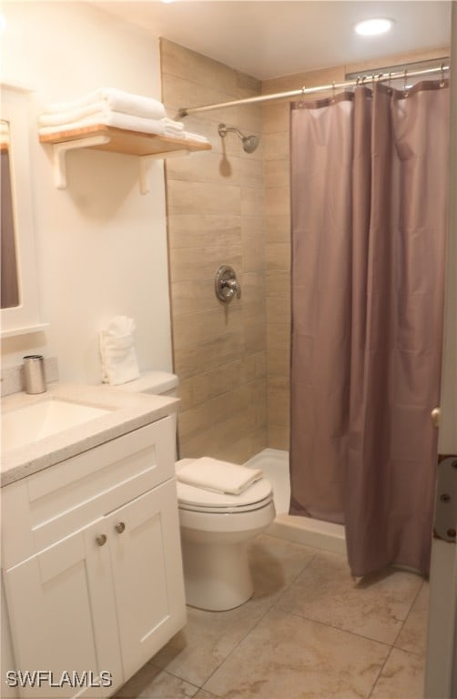 bathroom featuring vanity, toilet, and a shower with shower curtain