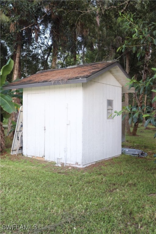 view of outbuilding with a yard