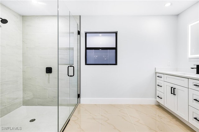 bathroom with vanity and a shower with shower door