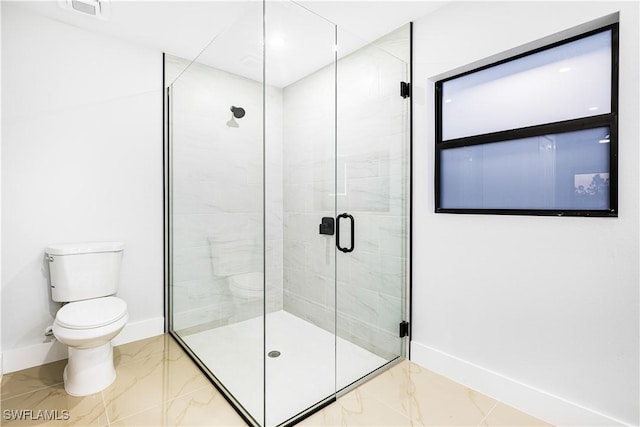 bathroom featuring walk in shower and toilet