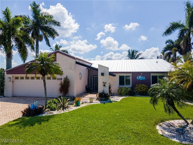 view of front facade with a front yard and a garage