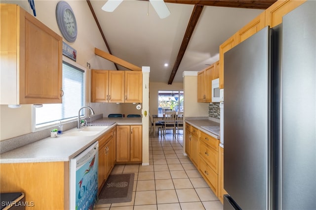 kitchen with light brown cabinets, stainless steel refrigerator, vaulted ceiling with beams, dishwasher, and sink