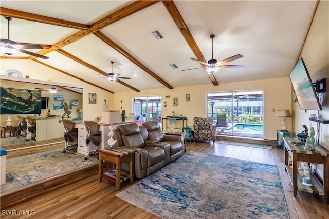 living room with lofted ceiling with beams and wood-type flooring