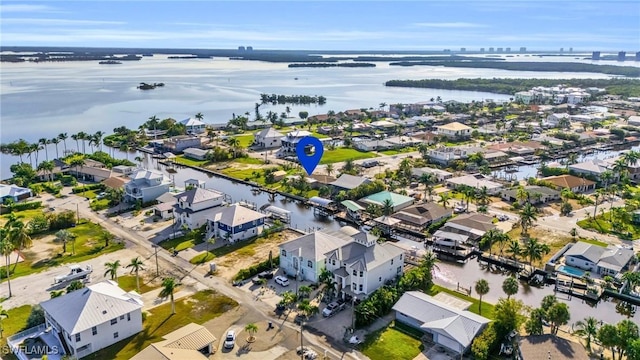 drone / aerial view featuring a water view and a residential view