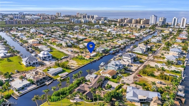 drone / aerial view featuring a view of city and a water view