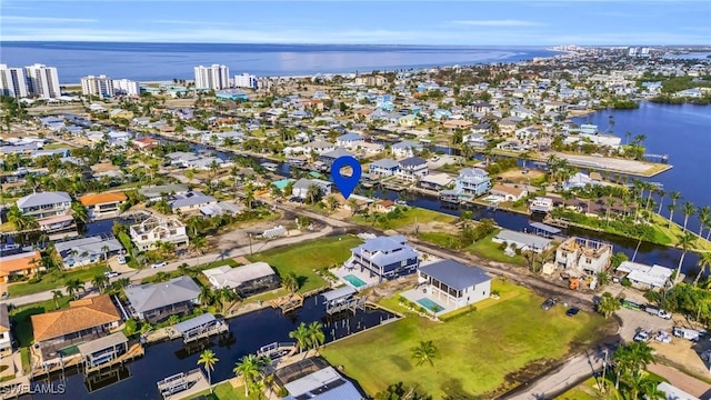 drone / aerial view featuring a water view and a residential view