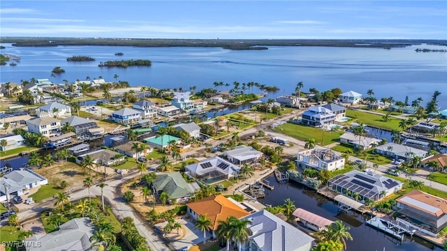 birds eye view of property featuring a water view and a residential view