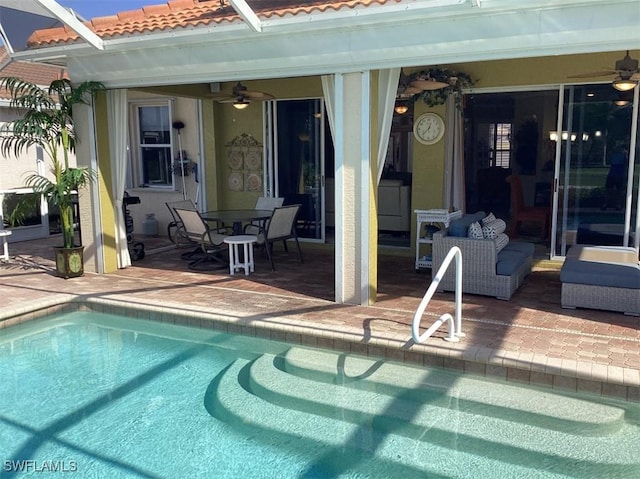 view of swimming pool with ceiling fan and a patio