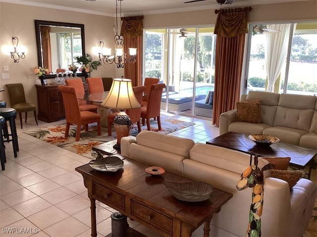 living room with ceiling fan with notable chandelier, light tile patterned floors, and crown molding