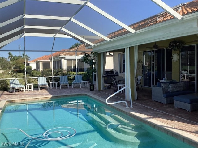 view of pool with a lanai, ceiling fan, and a patio area