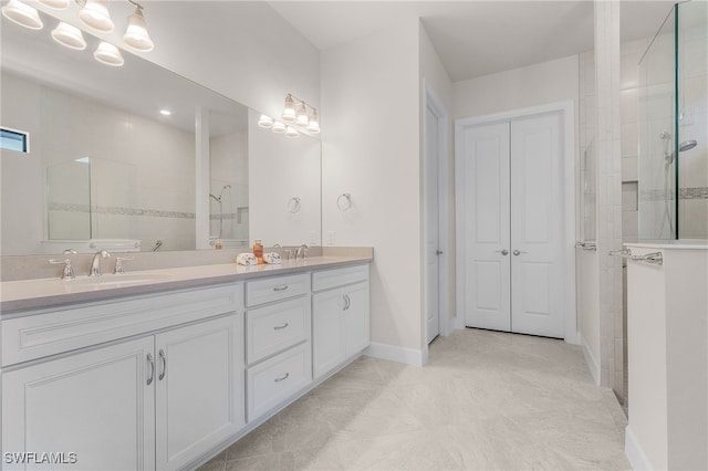 bathroom with vanity and a tile shower