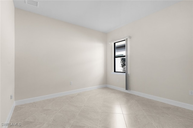 empty room with light tile patterned flooring