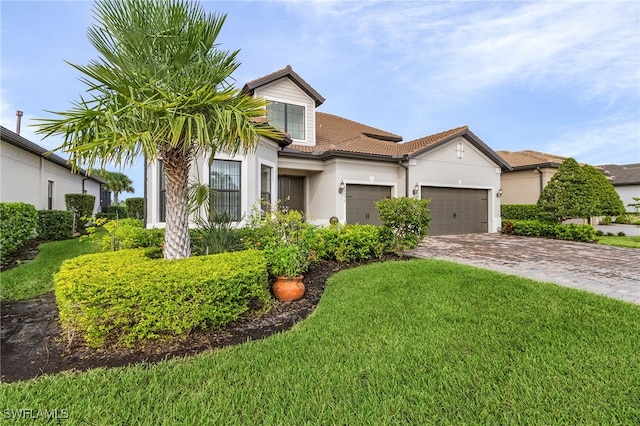 view of front of home featuring a front yard and a garage