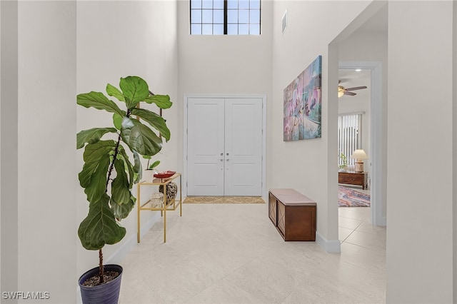 tiled entryway featuring a high ceiling