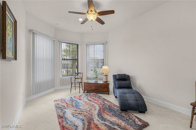 sitting room featuring light tile patterned floors and ceiling fan