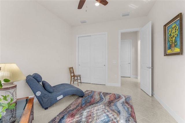 sitting room with ceiling fan and light tile patterned flooring