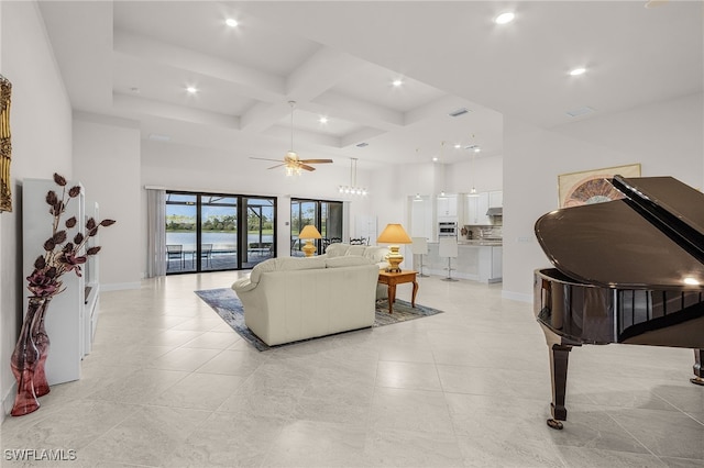 living room with coffered ceiling, ceiling fan, a towering ceiling, beamed ceiling, and light tile patterned flooring