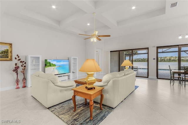 living room with ceiling fan, beamed ceiling, a high ceiling, and coffered ceiling