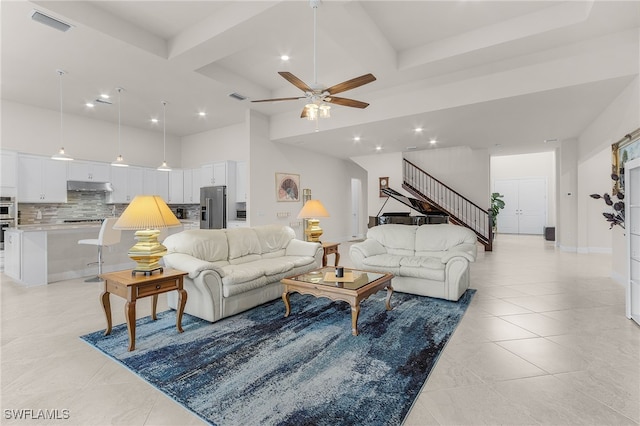 living room with ceiling fan and beamed ceiling