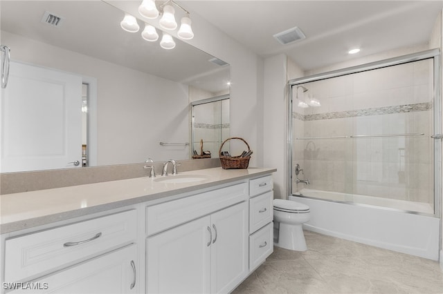 full bathroom with tile patterned flooring, vanity, toilet, and bath / shower combo with glass door