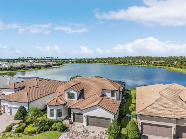 birds eye view of property with a water view