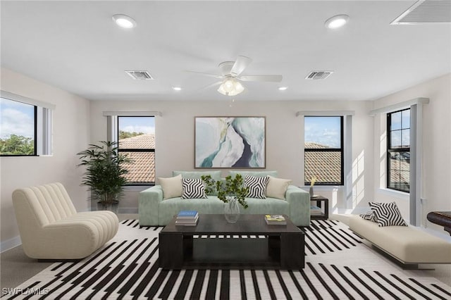 carpeted living room with ceiling fan