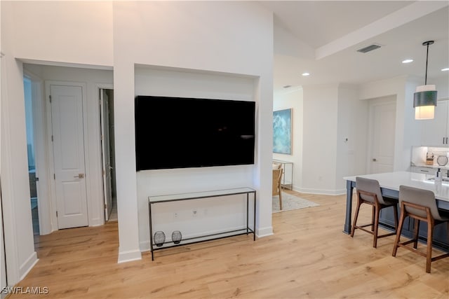 living room with light wood-type flooring and lofted ceiling