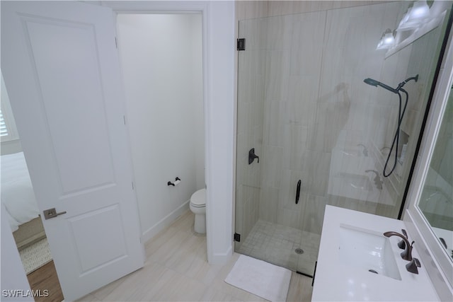 bathroom featuring walk in shower, vanity, and toilet