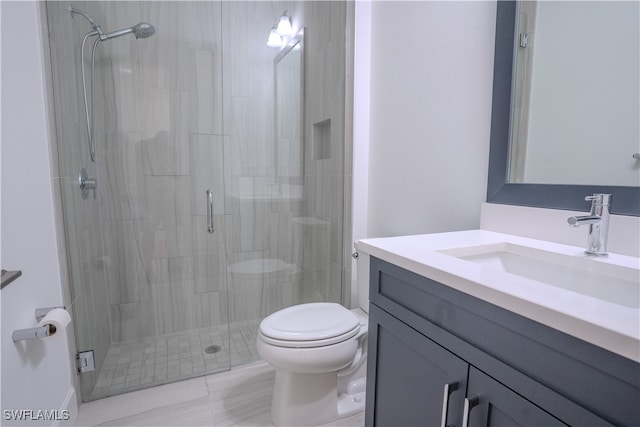 bathroom with an enclosed shower, vanity, and toilet