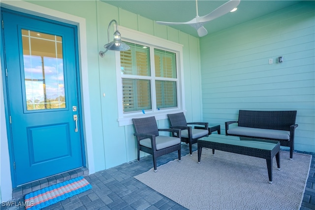 entrance to property with ceiling fan and a patio area