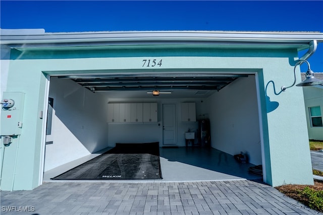 garage with a garage door opener and electric water heater