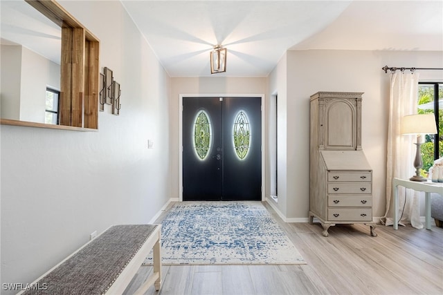 foyer entrance with light hardwood / wood-style flooring