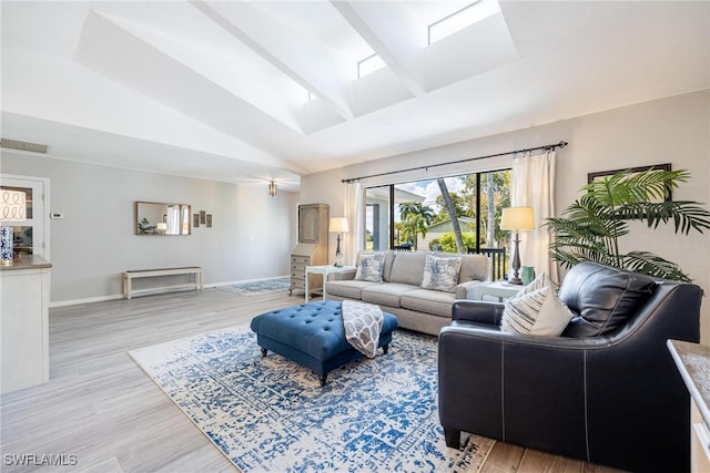 living room featuring light wood-type flooring and vaulted ceiling