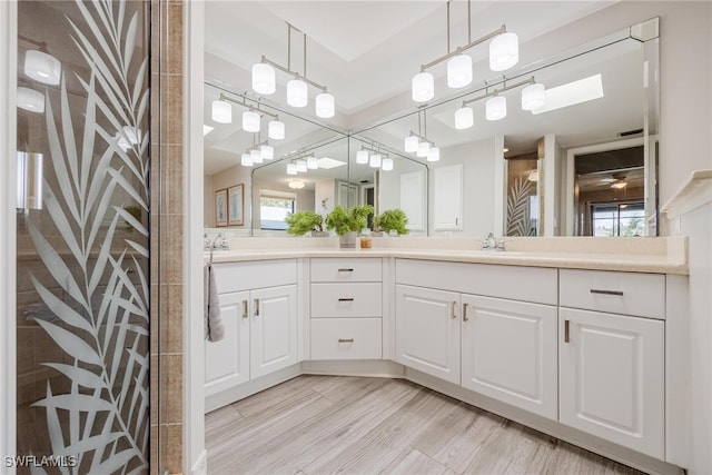 bathroom with plenty of natural light, vanity, hardwood / wood-style flooring, and a shower with shower door