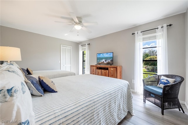 bedroom with hardwood / wood-style flooring, ceiling fan, and a closet