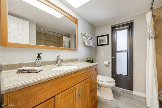 bathroom featuring toilet, a shower with curtain, vanity, and hardwood / wood-style flooring