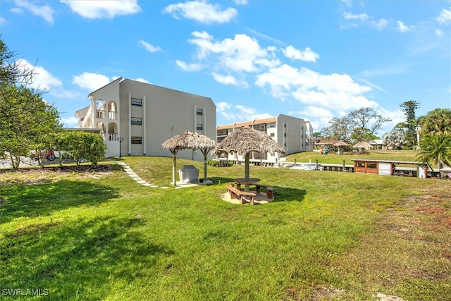 view of property's community with a gazebo and a yard