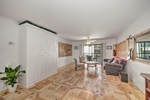 living room featuring ceiling fan and light parquet flooring