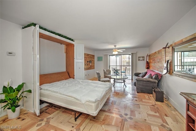 bedroom with access to outside, multiple windows, and a ceiling fan