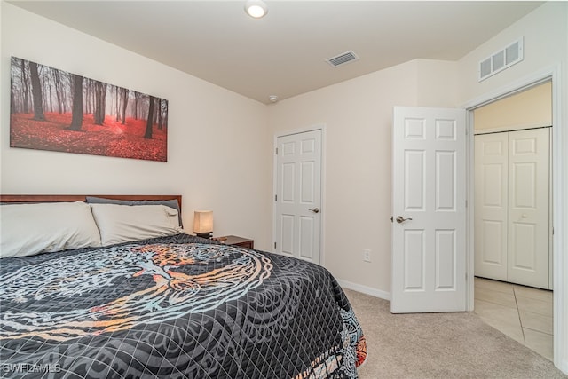 bedroom featuring a closet and light carpet