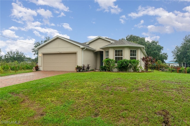 ranch-style house with a garage and a front lawn