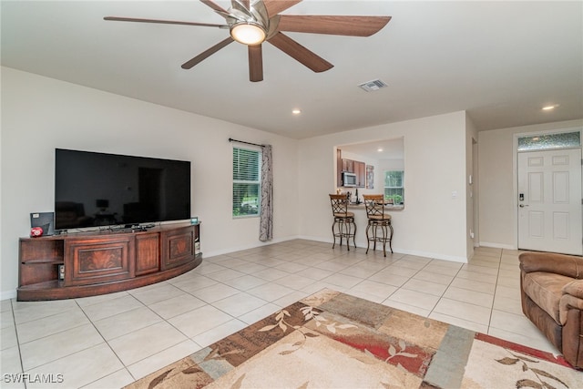 tiled living room featuring ceiling fan