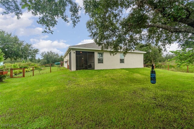 back of house featuring a lawn