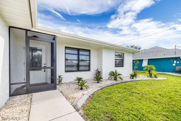 property entrance with a yard