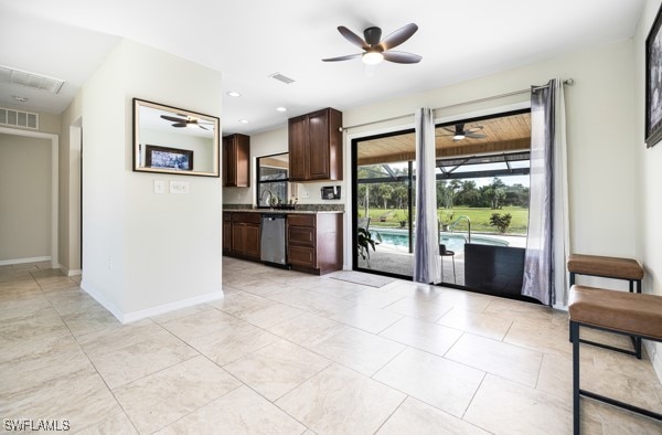 kitchen featuring stainless steel dishwasher, sink, dark brown cabinets, and ceiling fan