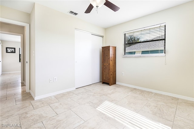 unfurnished bedroom featuring a closet and ceiling fan