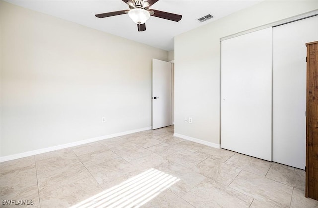 unfurnished bedroom featuring a closet and ceiling fan